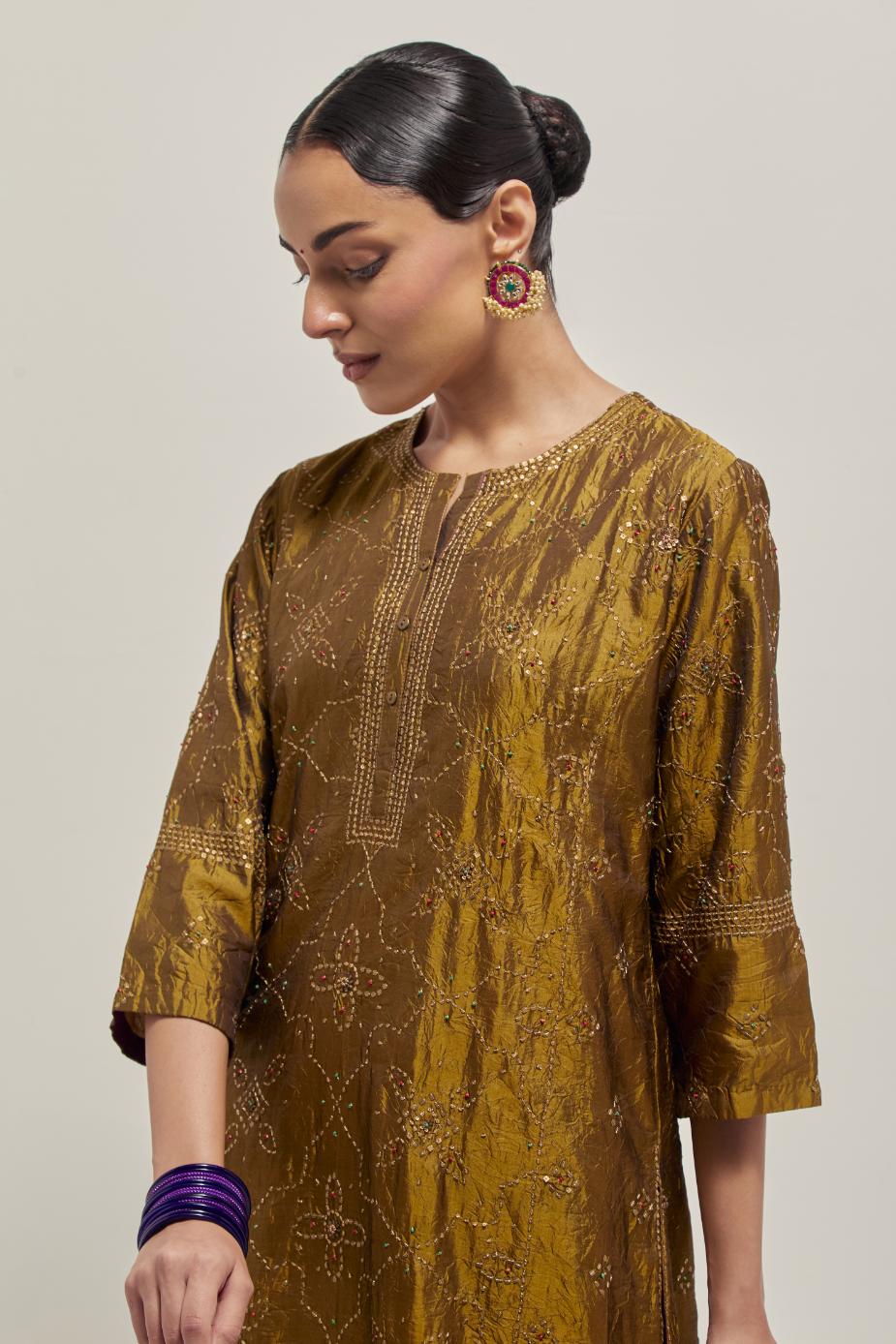Olive Silk kurta set with all-over hand embroidered sequins on bandhani inspired floral jaal and small square booti at side panels, highlighted with contrast-colored beads.