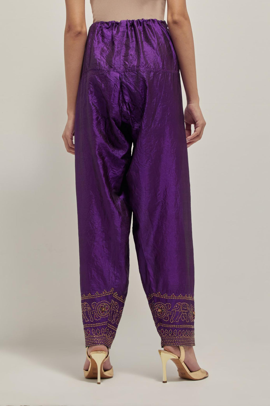Purple silk narrow salwar with a broad bandhani-inspired border at the hem, detailed with delicate bead and sequin work.