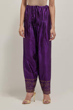 Purple silk narrow salwar with a broad bandhani-inspired border at the hem, detailed with delicate bead and sequin work.