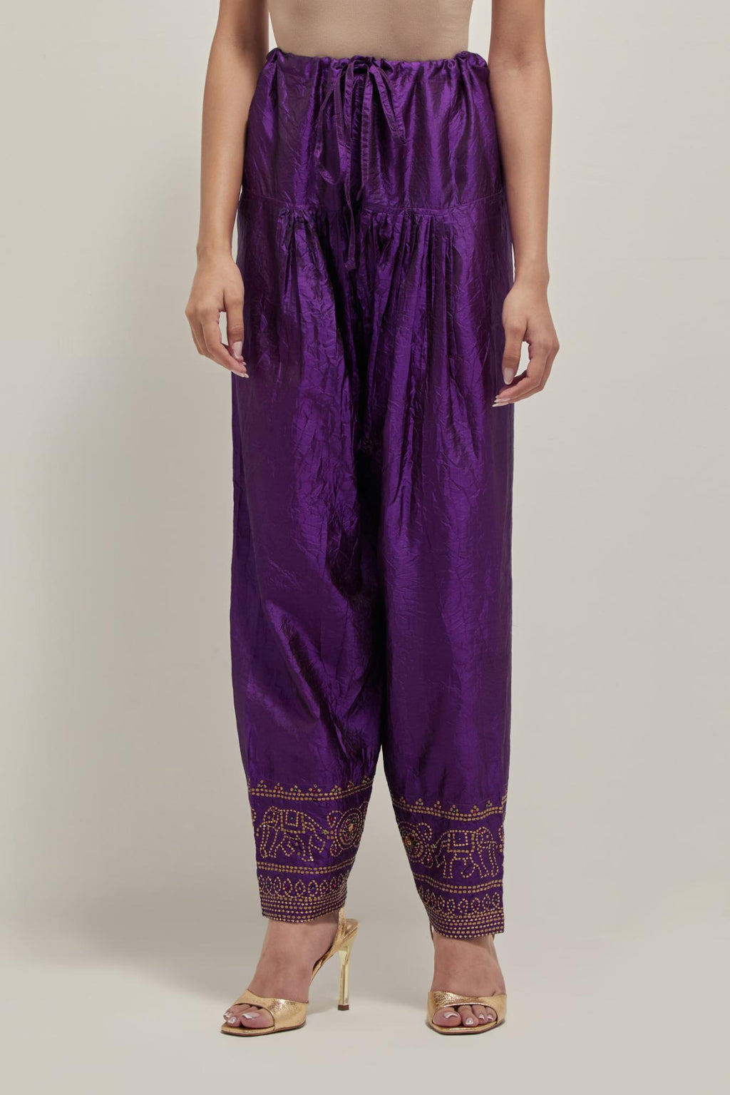 Purple silk narrow salwar with a broad bandhani-inspired border at the hem, detailed with delicate bead and sequin work.