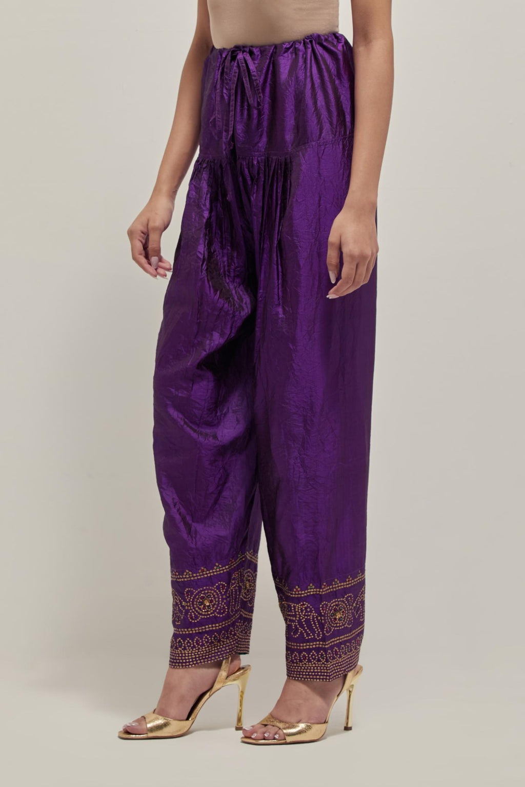 Purple silk narrow salwar with a broad bandhani-inspired border at the hem, detailed with delicate bead and sequin work.