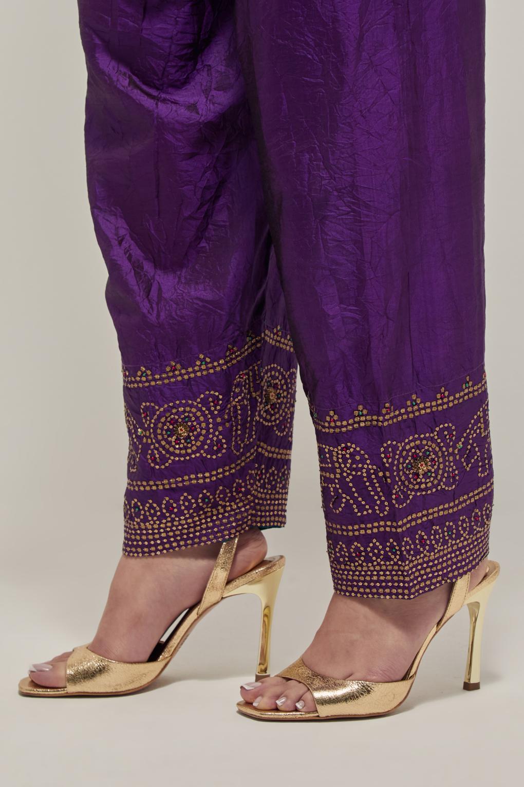 Purple silk narrow salwar with a broad bandhani-inspired border at the hem, detailed with delicate bead and sequin work.