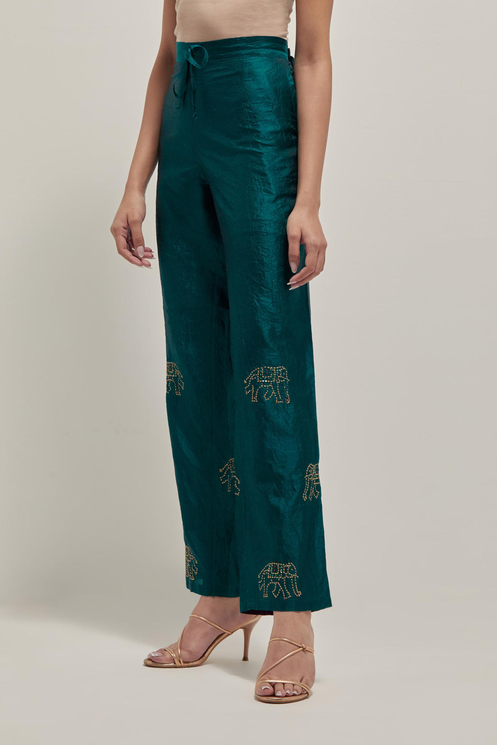 Teal Green silk pants with side pockets and assorted sequined elephants till mid-calf length.