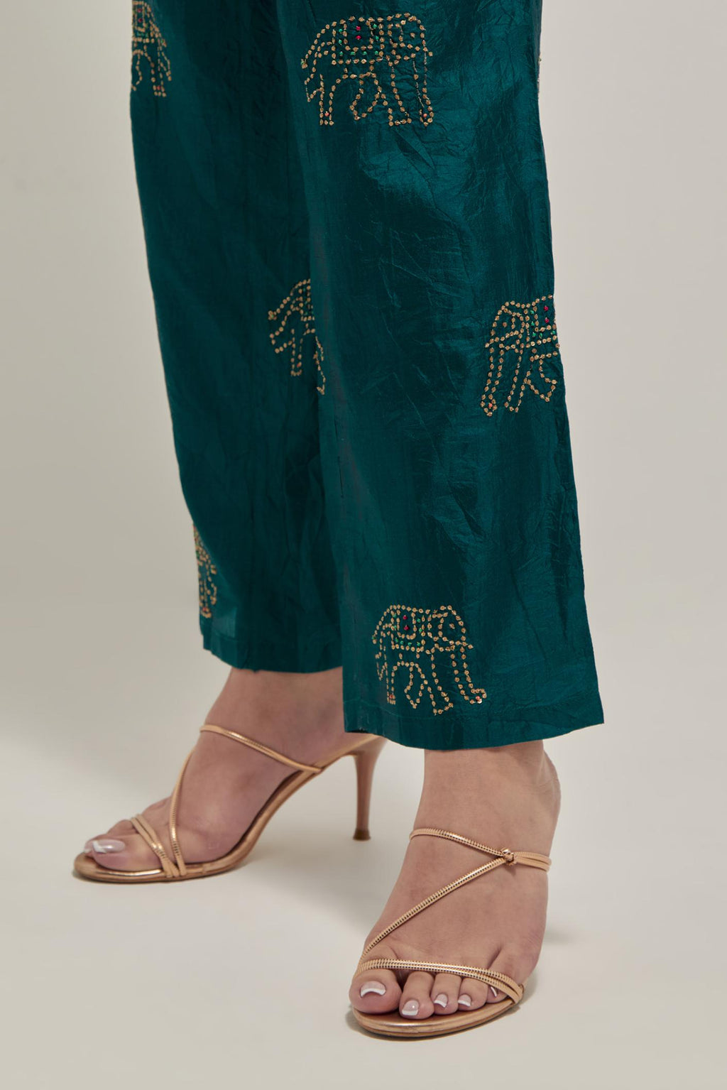 Teal Green silk pants with side pockets and assorted sequined elephants till mid-calf length.