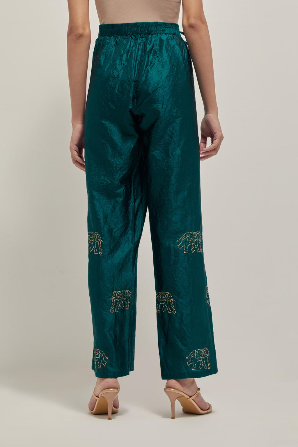 Teal Green silk pants with side pockets and assorted sequined elephants till mid-calf length.