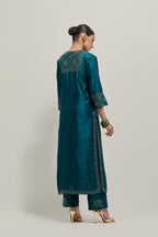 Teal Silk kurta set with hand embroidered sequins on bandhani inspired jaal work at neck, hem and sleeves cuff, highlighted with contrast-colored beads.