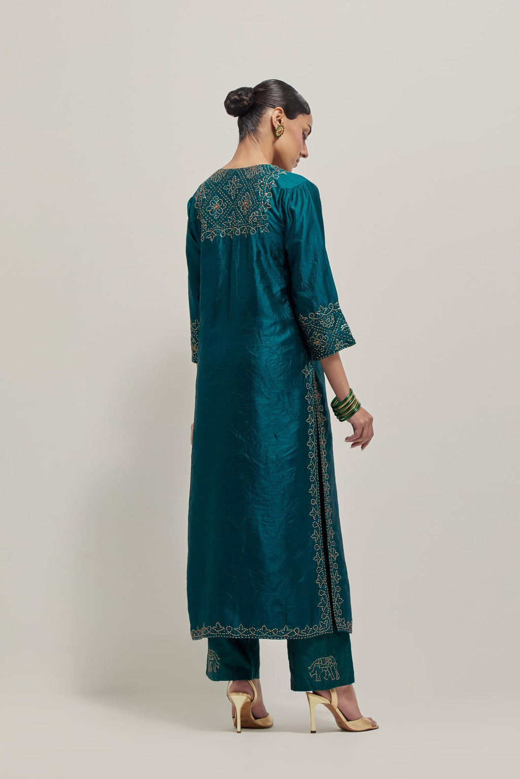 Teal Silk kurta set with hand embroidered sequins on bandhani inspired jaal work at neck, hem and sleeves cuff, highlighted with contrast-colored beads.