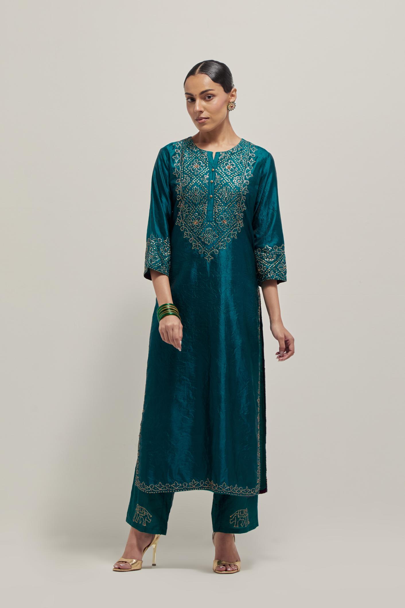 Teal Silk kurta set with hand embroidered sequins on bandhani inspired jaal work at neck, hem and sleeves cuff, highlighted with contrast-colored beads.