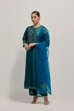 Teal Silk kurta set with hand embroidered sequins on bandhani inspired jaal work at neck, hem and sleeves cuff, highlighted with contrast-colored beads.