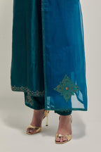 Teal Silk kurta set with hand embroidered sequins on bandhani inspired jaal work at neck, hem and sleeves cuff, highlighted with contrast-colored beads.