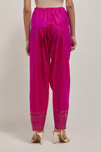 Fuchsia silk narrow salwar with a broad bandhani-inspired border at the hem, detailed with delicate bead and sequin work.