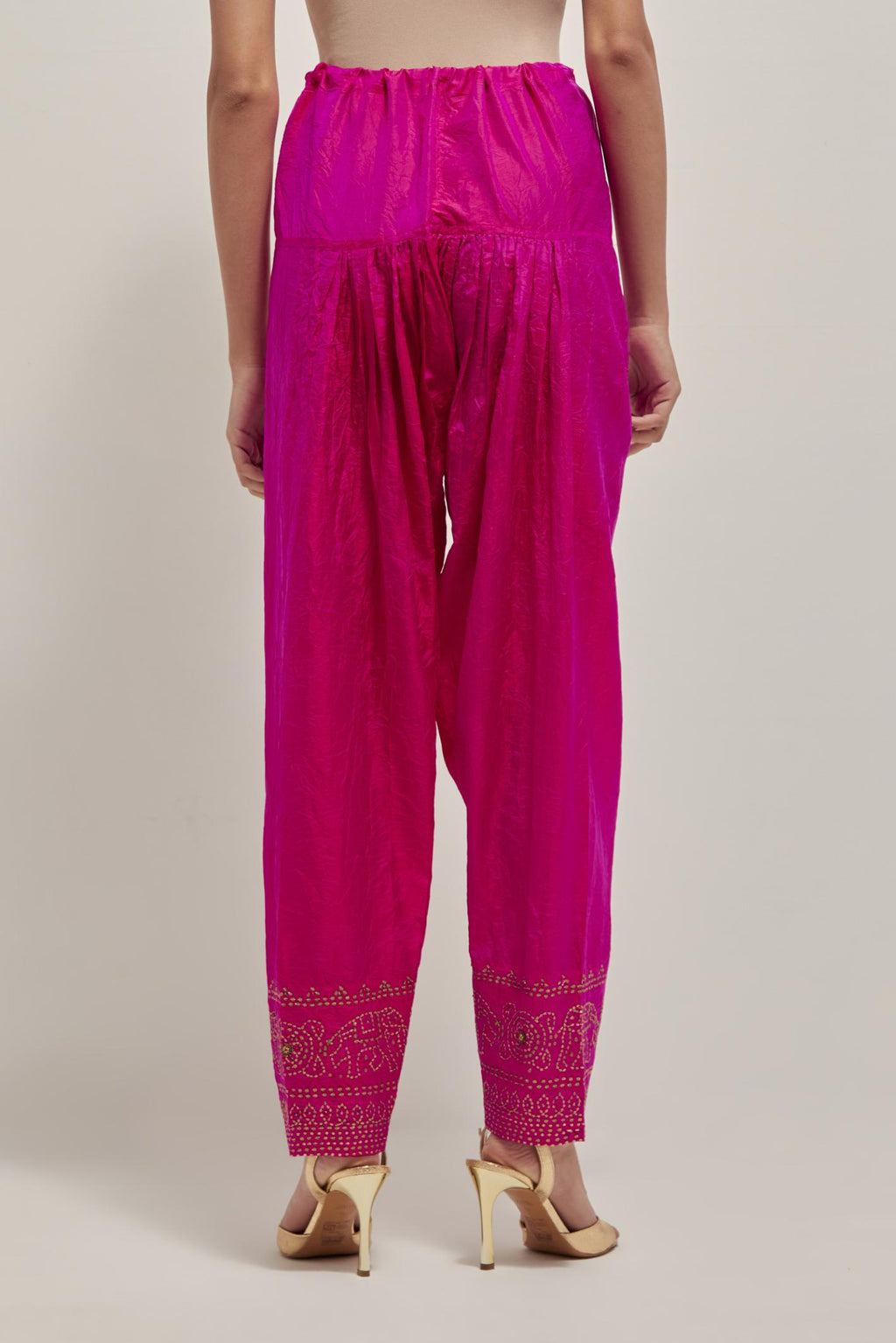 Fuchsia silk narrow salwar with a broad bandhani-inspired border at the hem, detailed with delicate bead and sequin work.