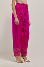 Fuchsia silk narrow salwar with a broad bandhani-inspired border at the hem, detailed with delicate bead and sequin work.