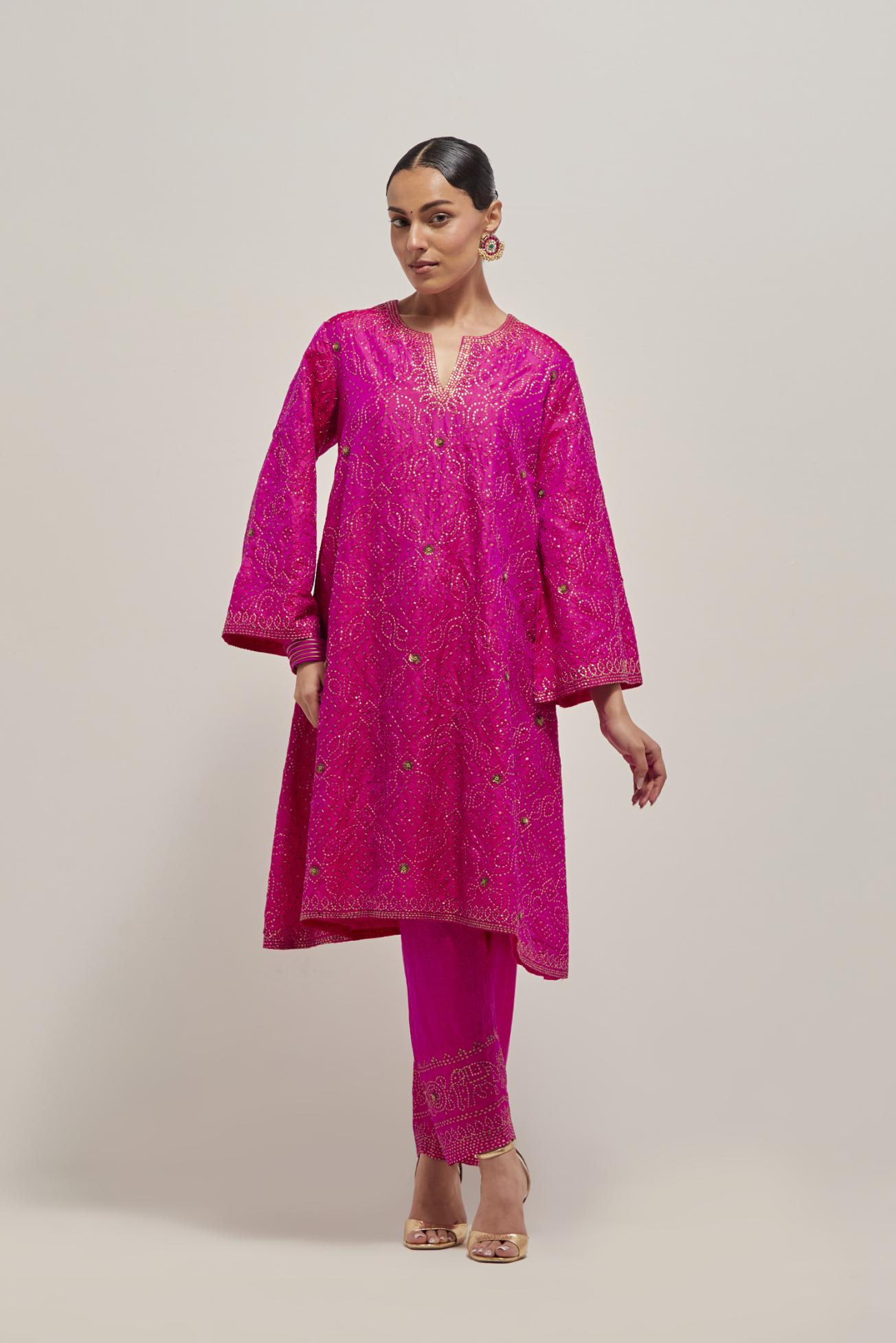 Fuchsia silk A-line kurta set with hand embroidered sequins on bandhani inspired jaal all-over the kurta, highlighted with contrast-colored beads.