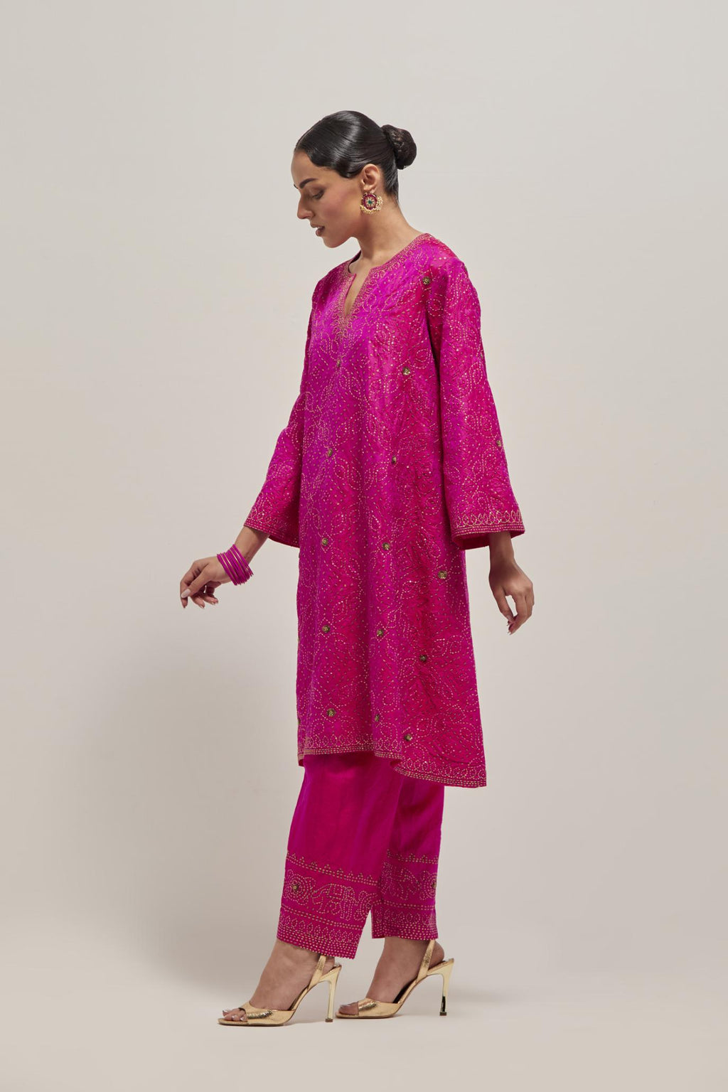 Fuchsia silk A-line kurta set with hand embroidered sequins on bandhani inspired jaal all-over the kurta, highlighted with contrast-colored beads.