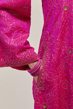 Fuchsia silk A-line kurta set with hand embroidered sequins on bandhani inspired jaal all-over the kurta, highlighted with contrast-colored beads.