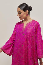 Fuchsia silk A-line kurta set with hand embroidered sequins on bandhani inspired jaal all-over the kurta, highlighted with contrast-colored beads.