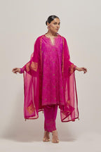 Fuchsia silk A-line kurta set with hand embroidered sequins on bandhani inspired jaal all-over the kurta, highlighted with contrast-colored beads.