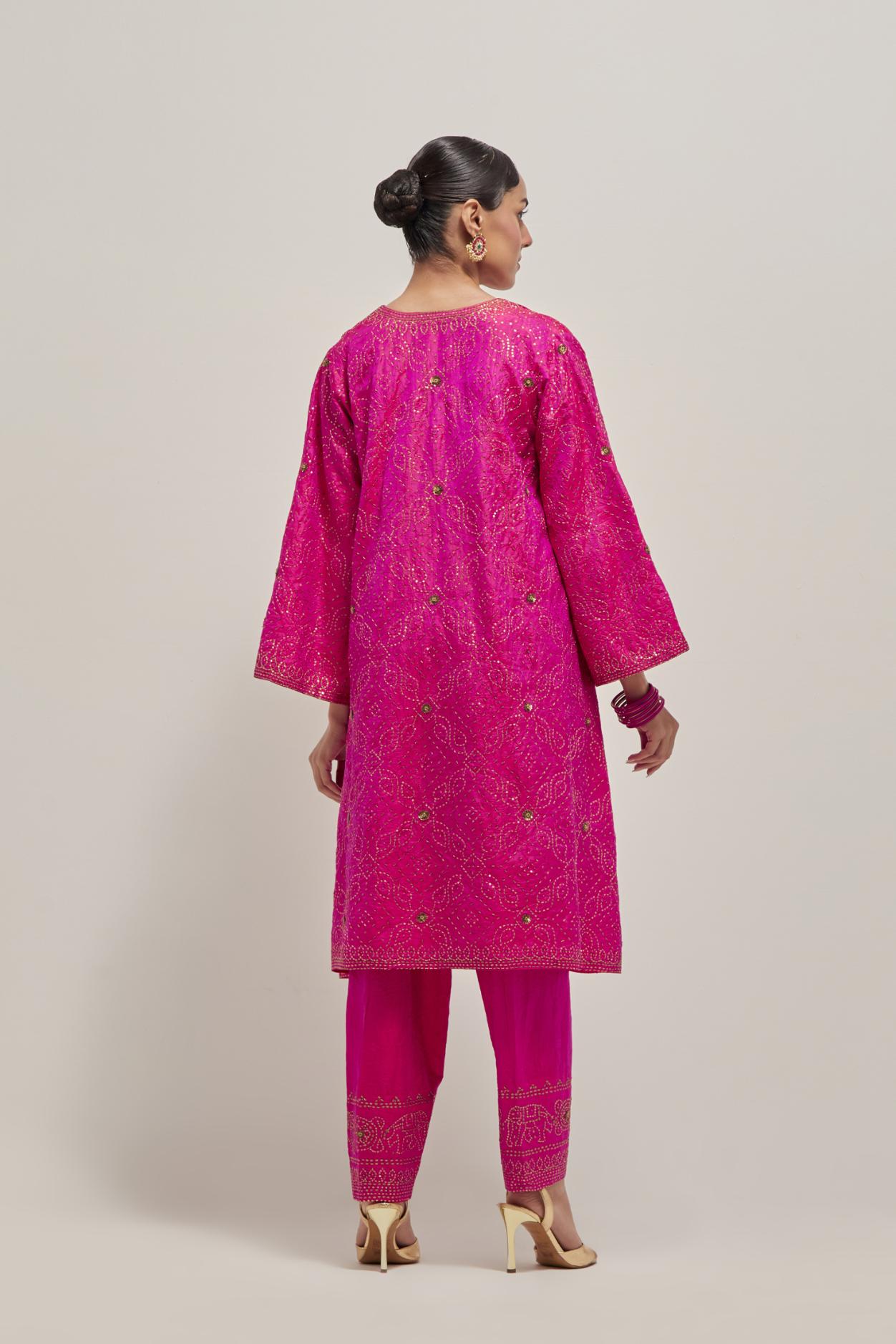 Fuchsia silk A-line kurta set with hand embroidered sequins on bandhani inspired jaal all-over the kurta, highlighted with contrast-colored beads.
