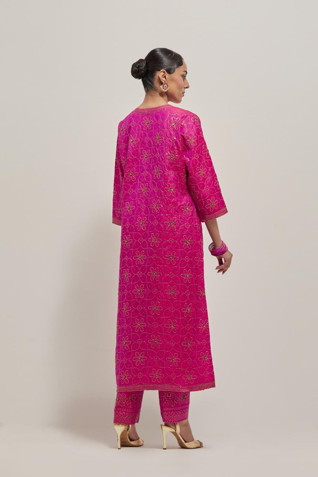 Fuchsia silk straight kurta set with hand embroidered sequins on bandhani inspired floral jaal all-over the kurta, highlighted with contrast-colored beads.