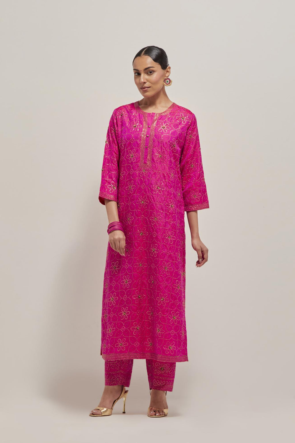 Fuchsia silk straight kurta set with hand embroidered sequins on bandhani inspired floral jaal all-over the kurta, highlighted with contrast-colored beads.