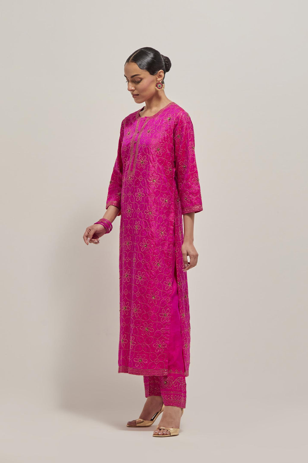 Fuchsia silk straight kurta set with hand embroidered sequins on bandhani inspired floral jaal all-over the kurta, highlighted with contrast-colored beads.
