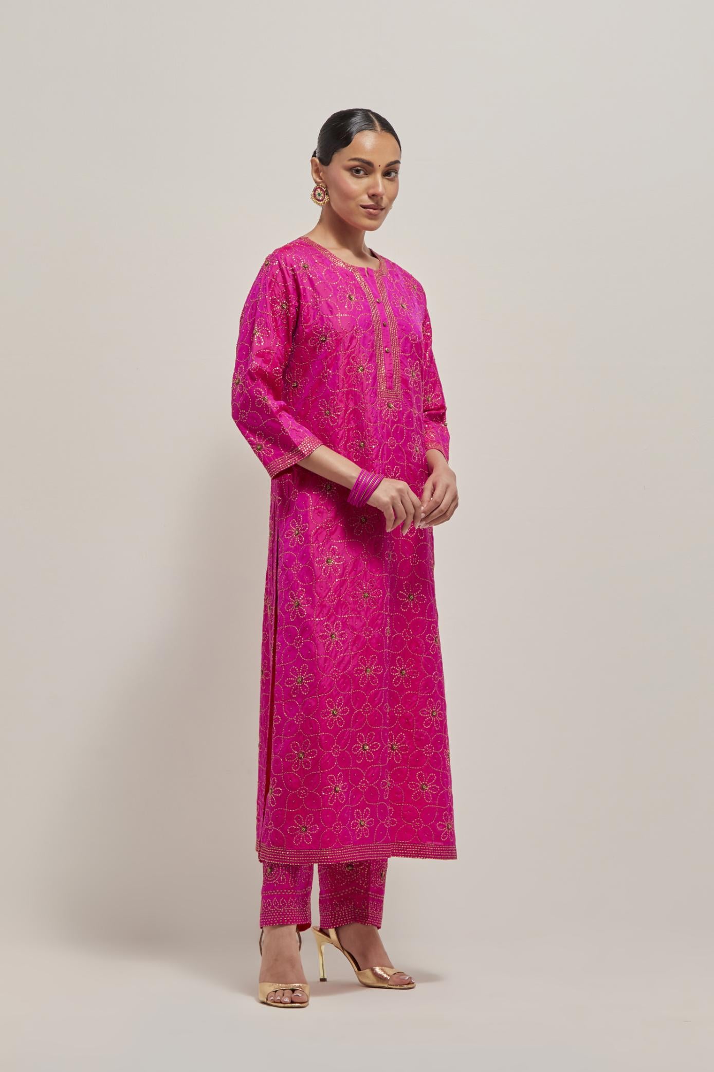 Fuchsia silk straight kurta set with hand embroidered sequins on bandhani inspired floral jaal all-over the kurta, highlighted with contrast-colored beads.
