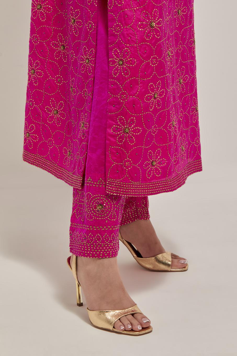 Fuchsia silk straight kurta set with hand embroidered sequins on bandhani inspired floral jaal all-over the kurta, highlighted with contrast-colored beads.