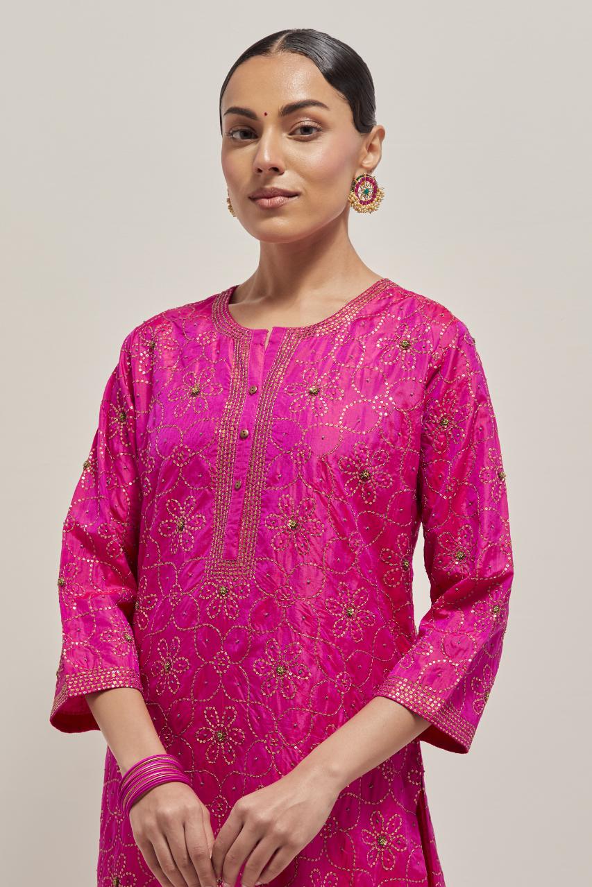Fuchsia silk straight kurta set with hand embroidered sequins on bandhani inspired floral jaal all-over the kurta, highlighted with contrast-colored beads.