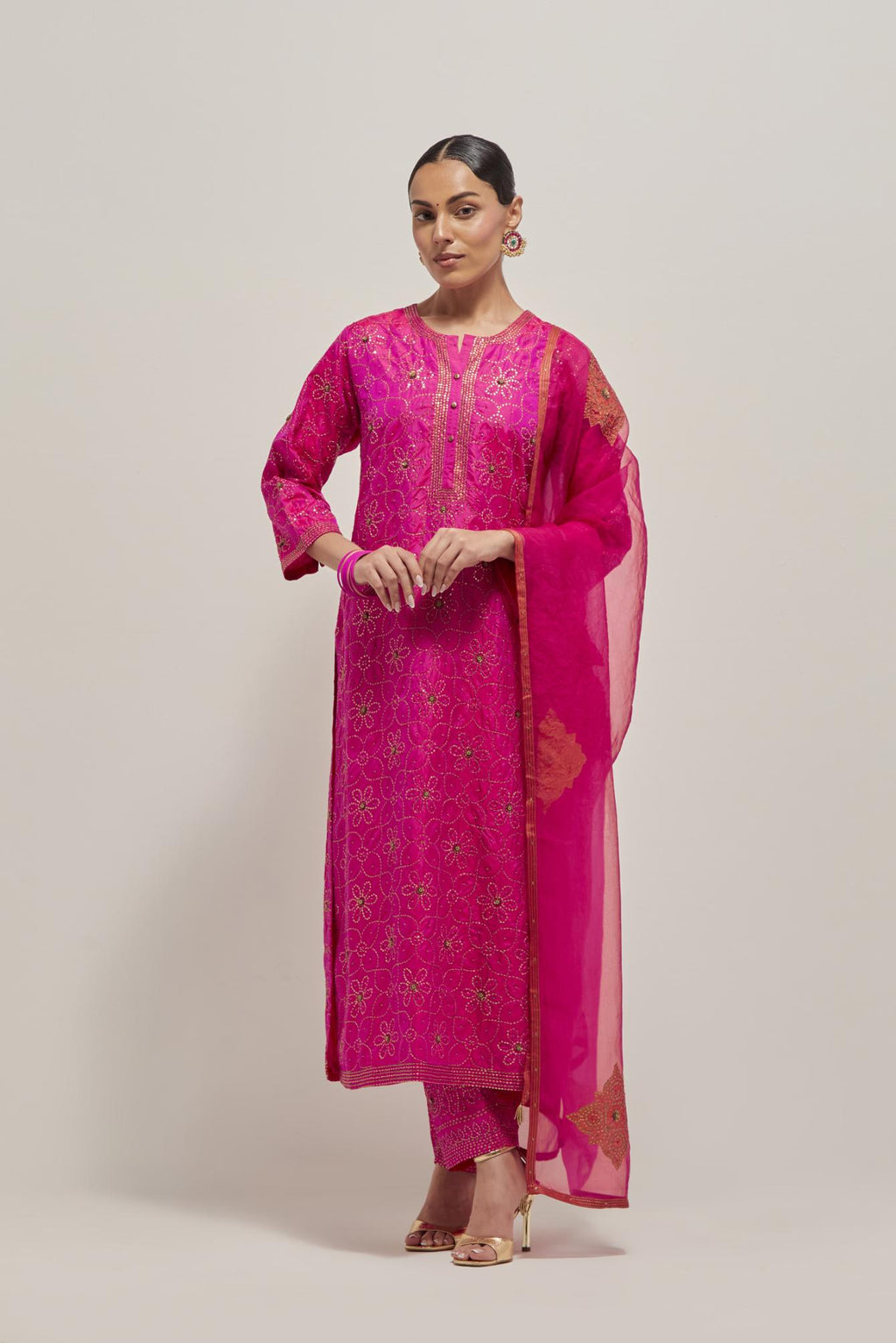 Fuchsia silk straight kurta set with hand embroidered sequins on bandhani inspired floral jaal all-over the kurta, highlighted with contrast-colored beads.