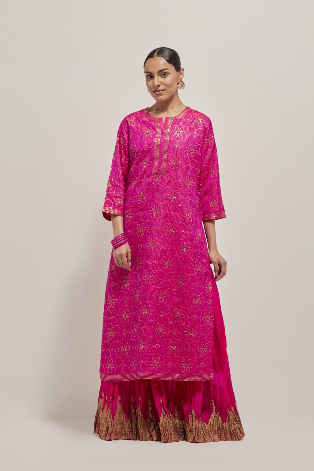 Fuchsia silk straight kurta set with hand embroidered sequins on bandhani inspired floral jaal all-over the kurta, highlighted with contrast-colored beads.