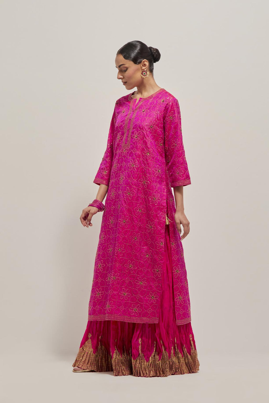 Fuchsia silk straight kurta set with hand embroidered sequins on bandhani inspired floral jaal all-over the kurta, highlighted with contrast-colored beads.