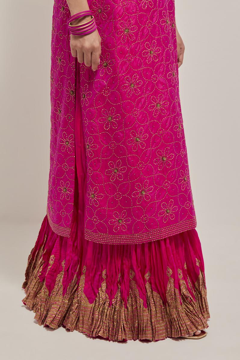 Fuchsia silk straight kurta set with hand embroidered sequins on bandhani inspired floral jaal all-over the kurta, highlighted with contrast-colored beads.