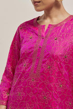 Fuchsia silk straight kurta set with hand embroidered sequins on bandhani inspired floral jaal all-over the kurta, highlighted with contrast-colored beads.