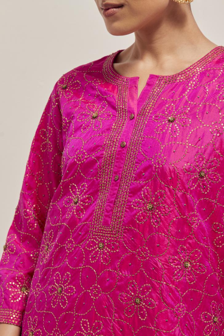 Fuchsia silk straight kurta set with hand embroidered sequins on bandhani inspired floral jaal all-over the kurta, highlighted with contrast-colored beads.