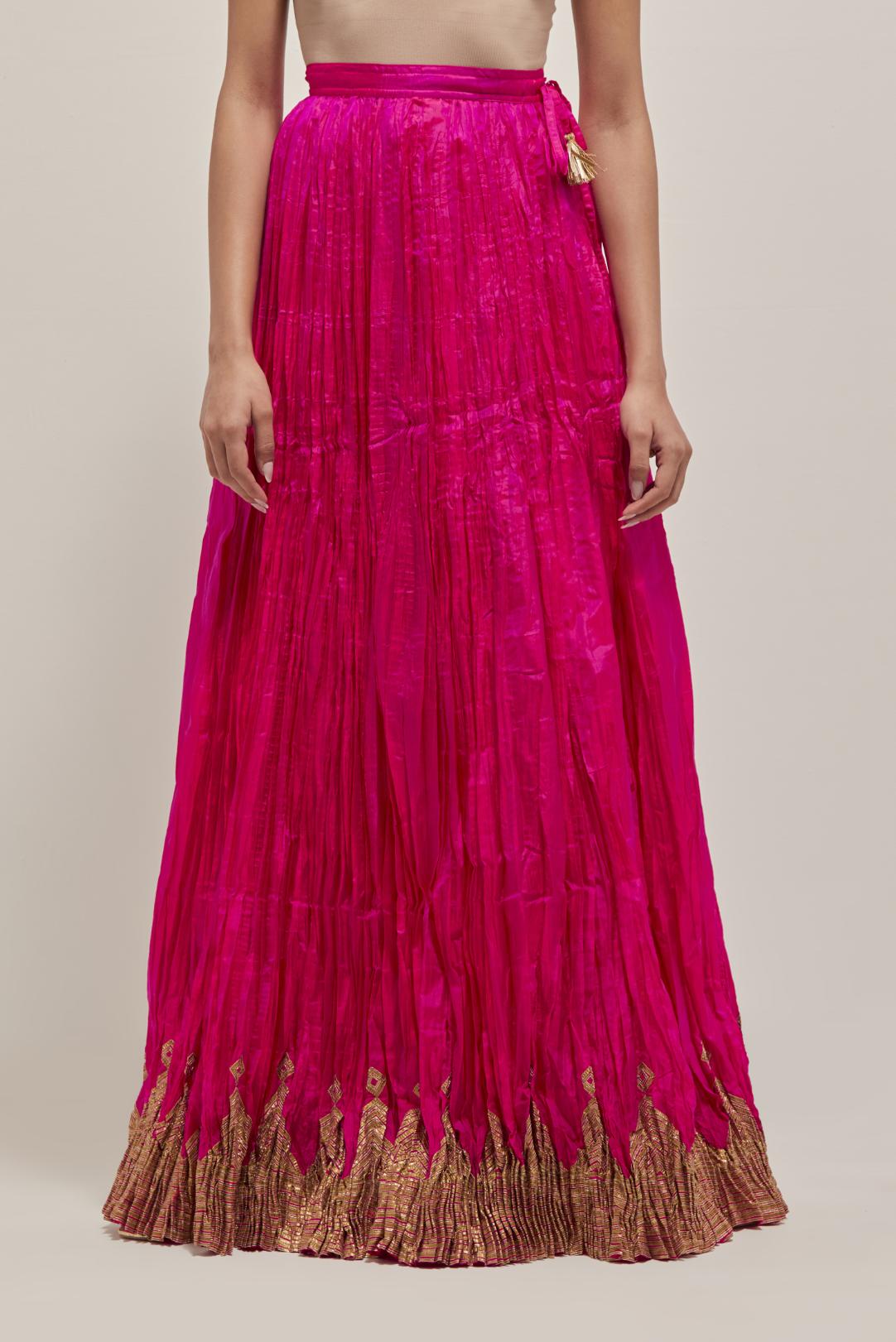 Fuchsia Silk 40 kali lehenga edged with dull gold gota embroidery and contrast silk facings.