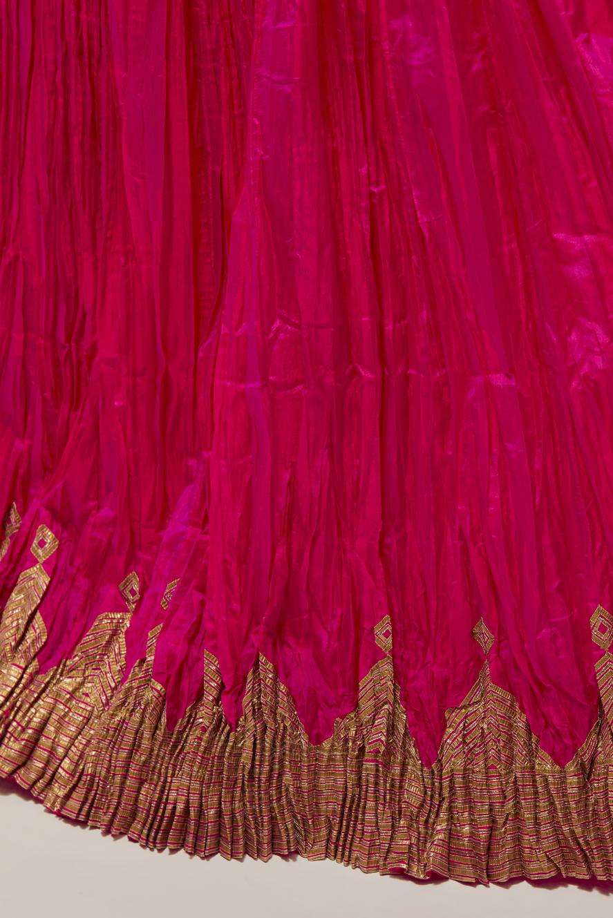 Fuchsia Silk 40 kali lehenga edged with dull gold gota embroidery and contrast silk facings.