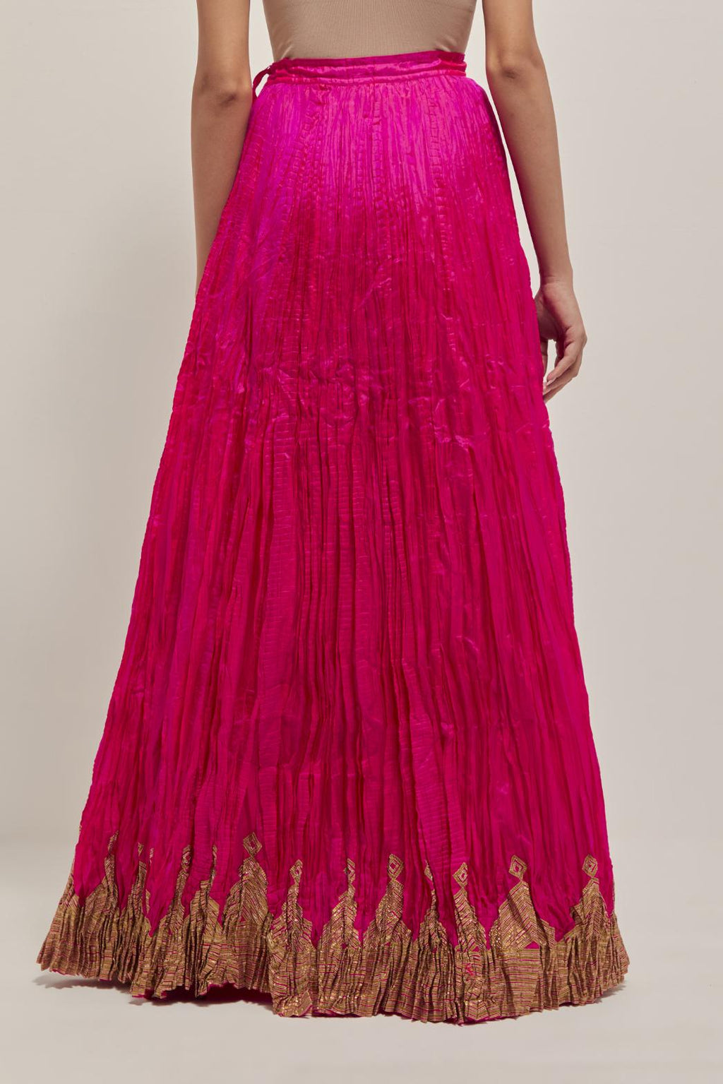 Fuchsia Silk 40 kali lehenga edged with dull gold gota embroidery and contrast silk facings.