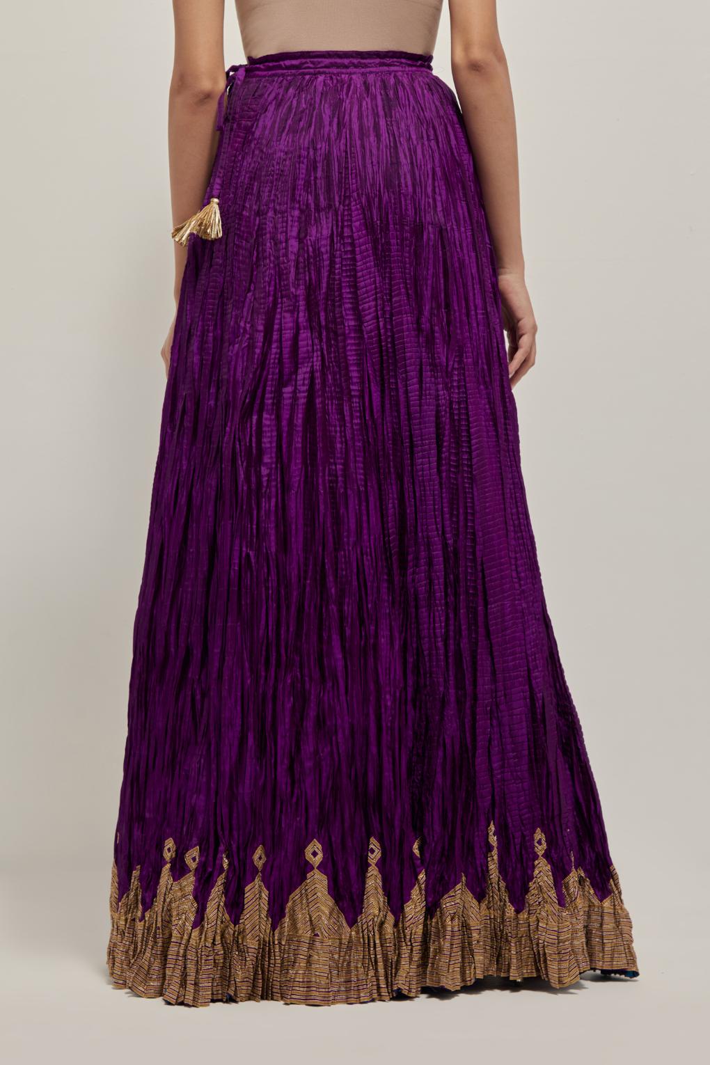 Purple Silk 40 kali lehenga edged with dull gold gota embroidery and contrast silk facings.