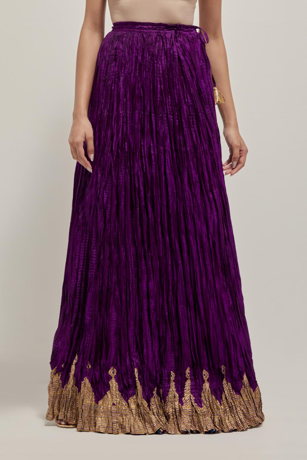 Purple Silk 40 kali lehenga edged with dull gold gota embroidery and contrast silk facings.