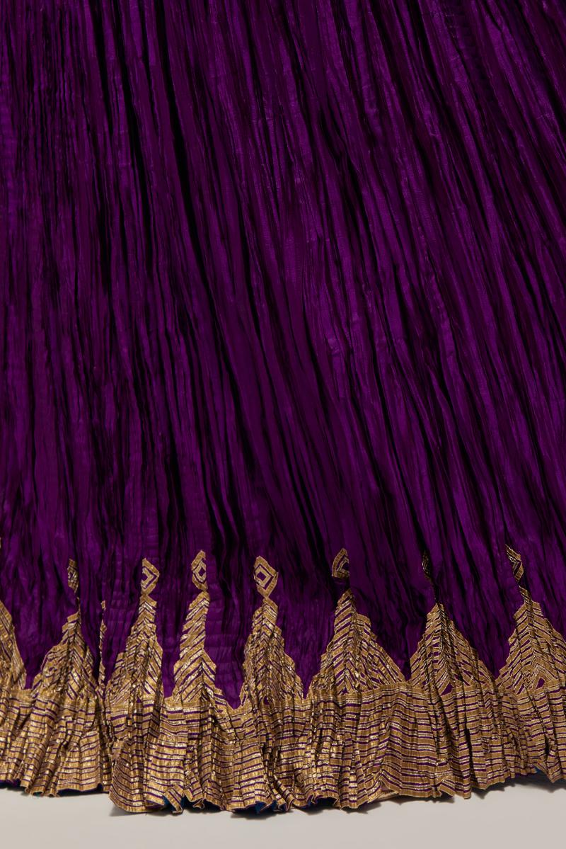 Purple Silk 40 kali lehenga edged with dull gold gota embroidery and contrast silk facings.