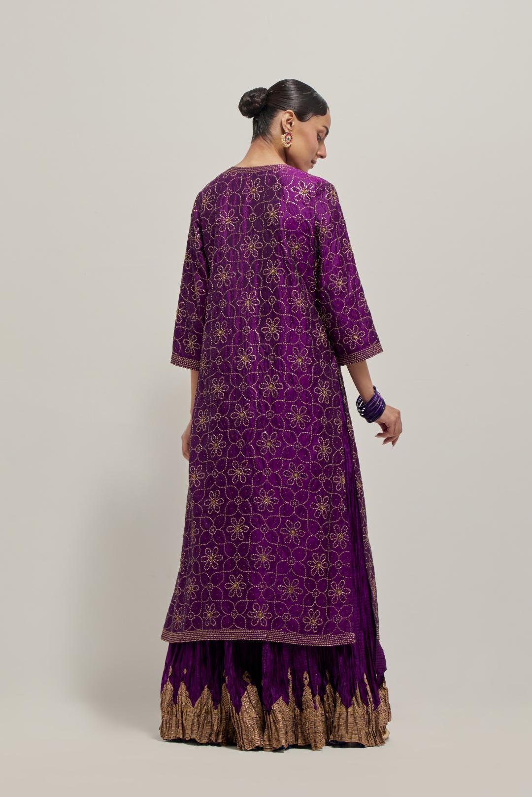 Purple silk straight kurta set with hand embroidered sequins on bandhani inspired floral jaal all-over the kurta, highlighted with contrast-colored beads.