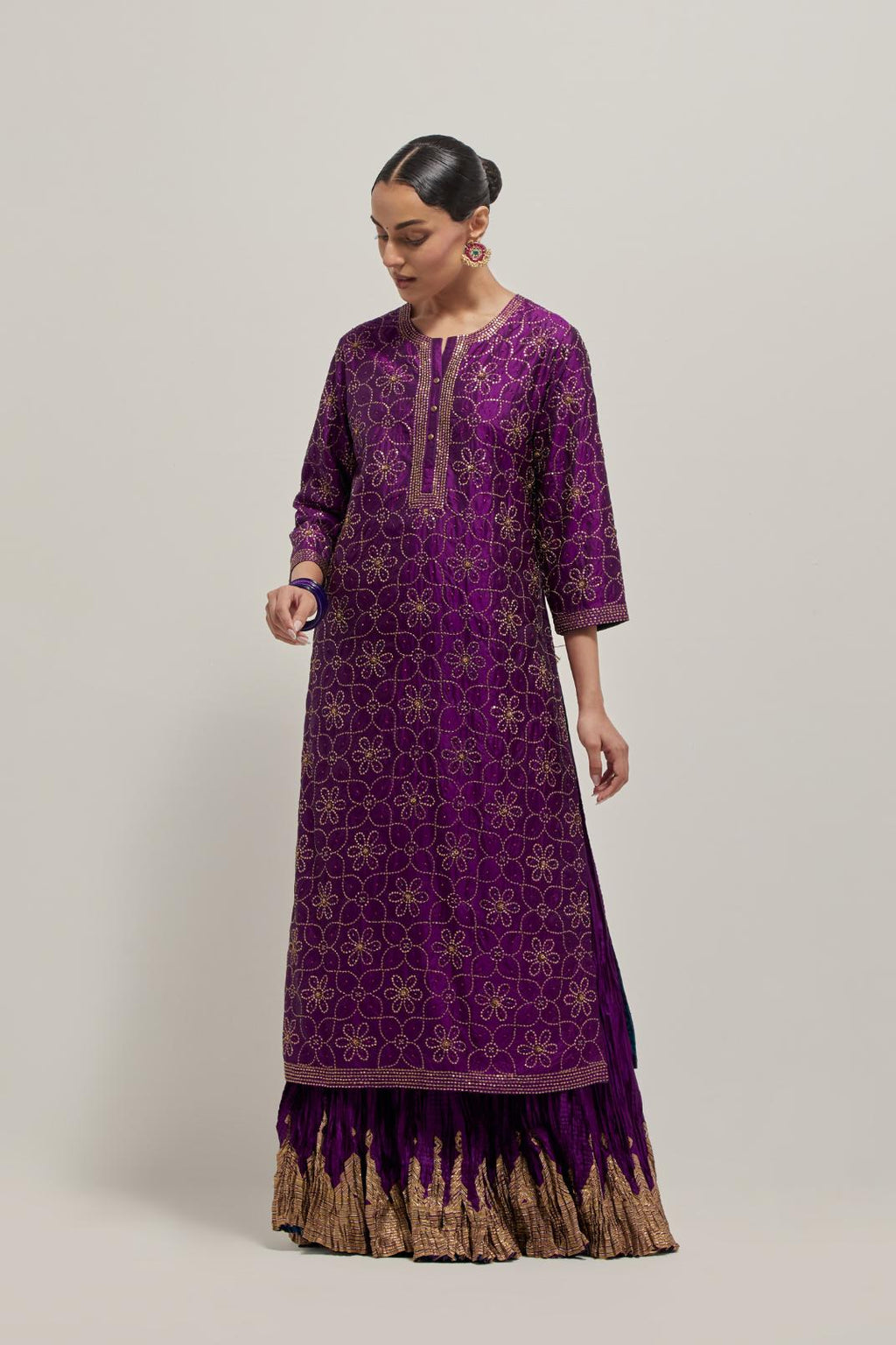 Purple silk straight kurta set with hand embroidered sequins on bandhani inspired floral jaal all-over the kurta, highlighted with contrast-colored beads.