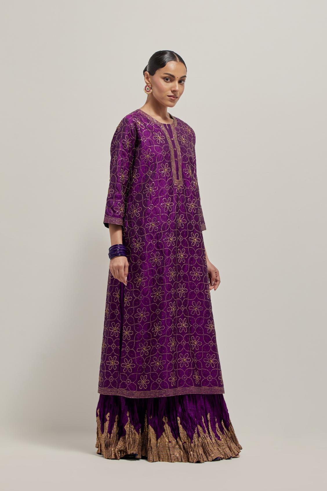 Purple silk straight kurta set with hand embroidered sequins on bandhani inspired floral jaal all-over the kurta, highlighted with contrast-colored beads.