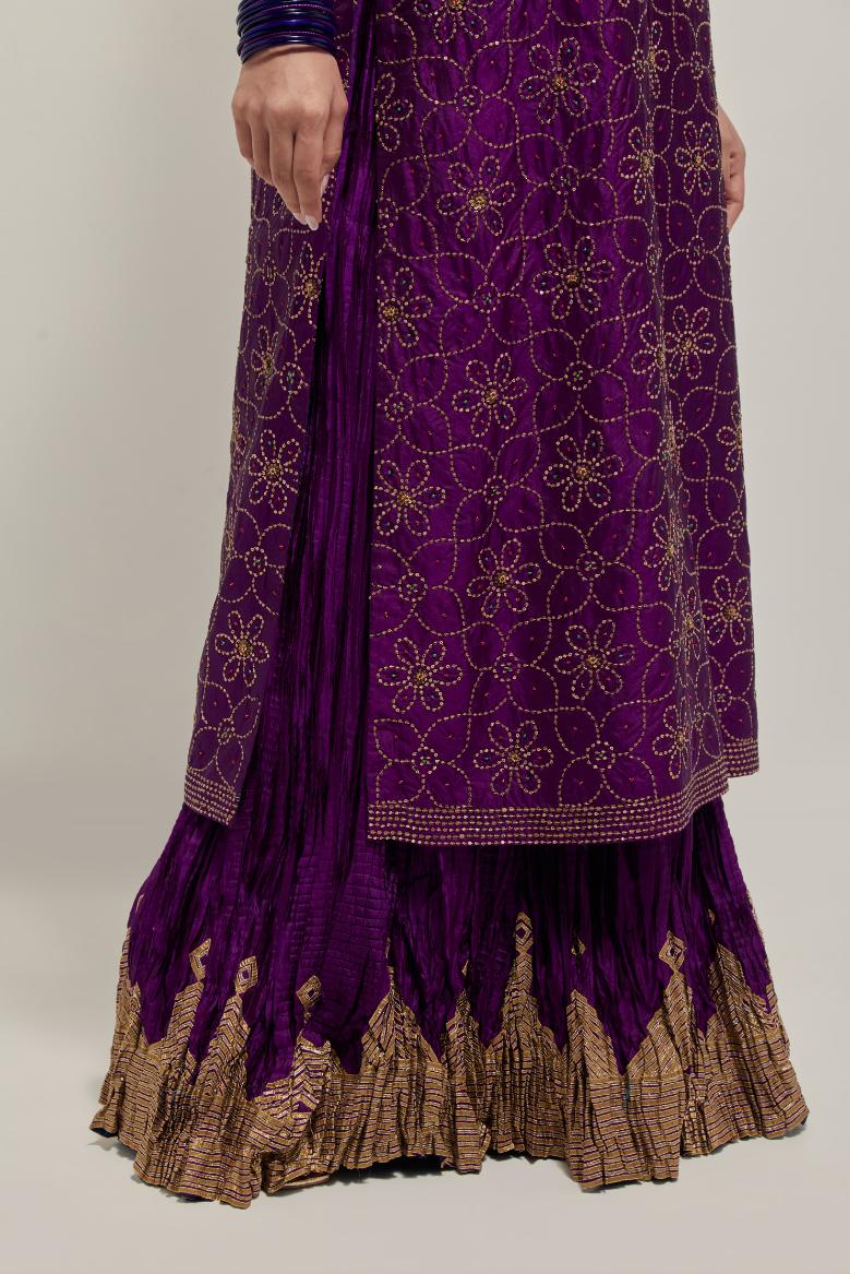 Purple silk straight kurta set with hand embroidered sequins on bandhani inspired floral jaal all-over the kurta, highlighted with contrast-colored beads.