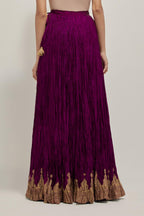 Wine Silk 40 kali lehenga edged with dull gold gota embroidery and contrast silk facings.