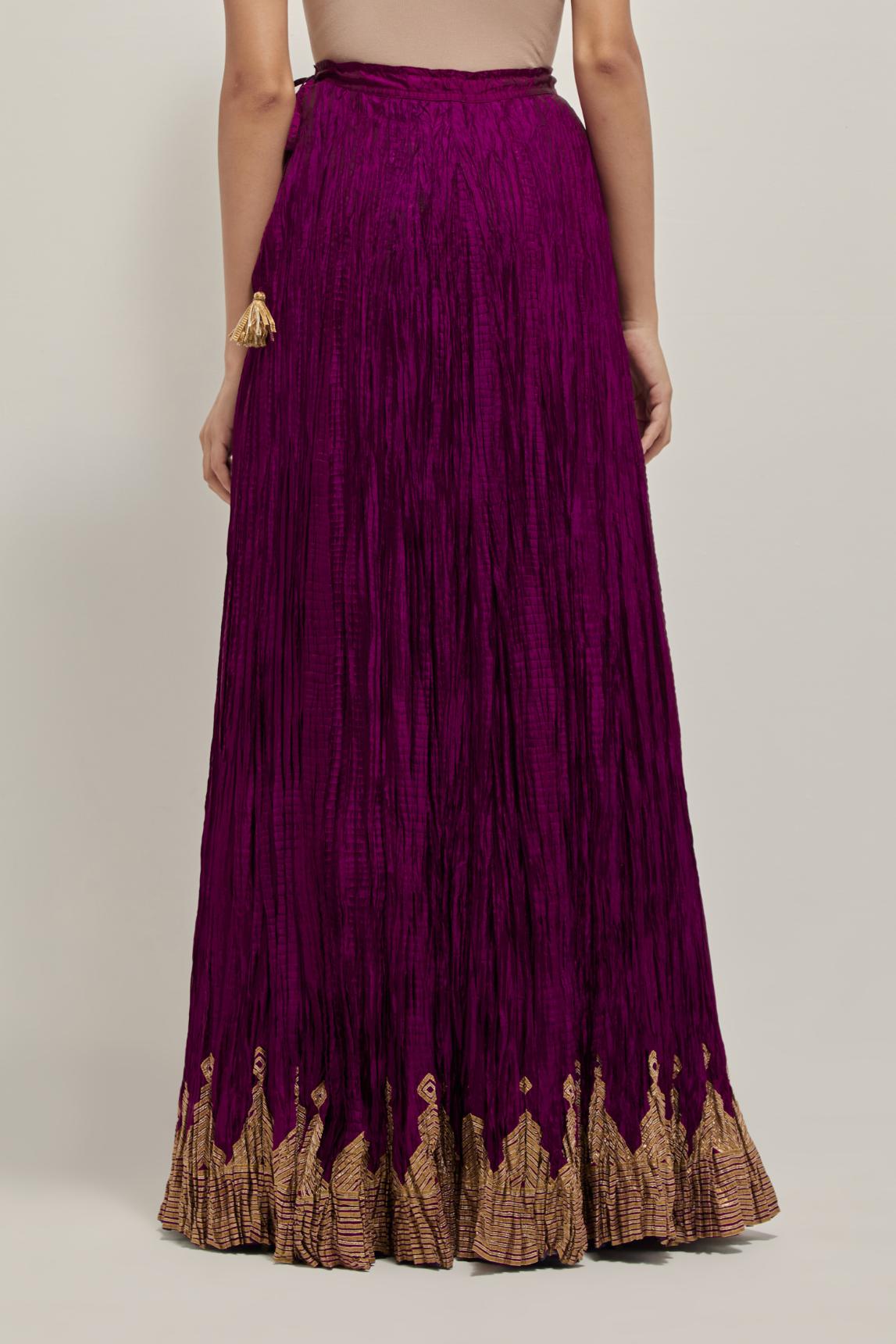 Wine Silk 40 kali lehenga edged with dull gold gota embroidery and contrast silk facings.