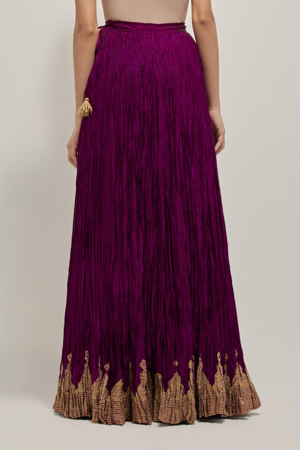 Wine Silk 40 kali lehenga edged with dull gold gota embroidery and contrast silk facings.