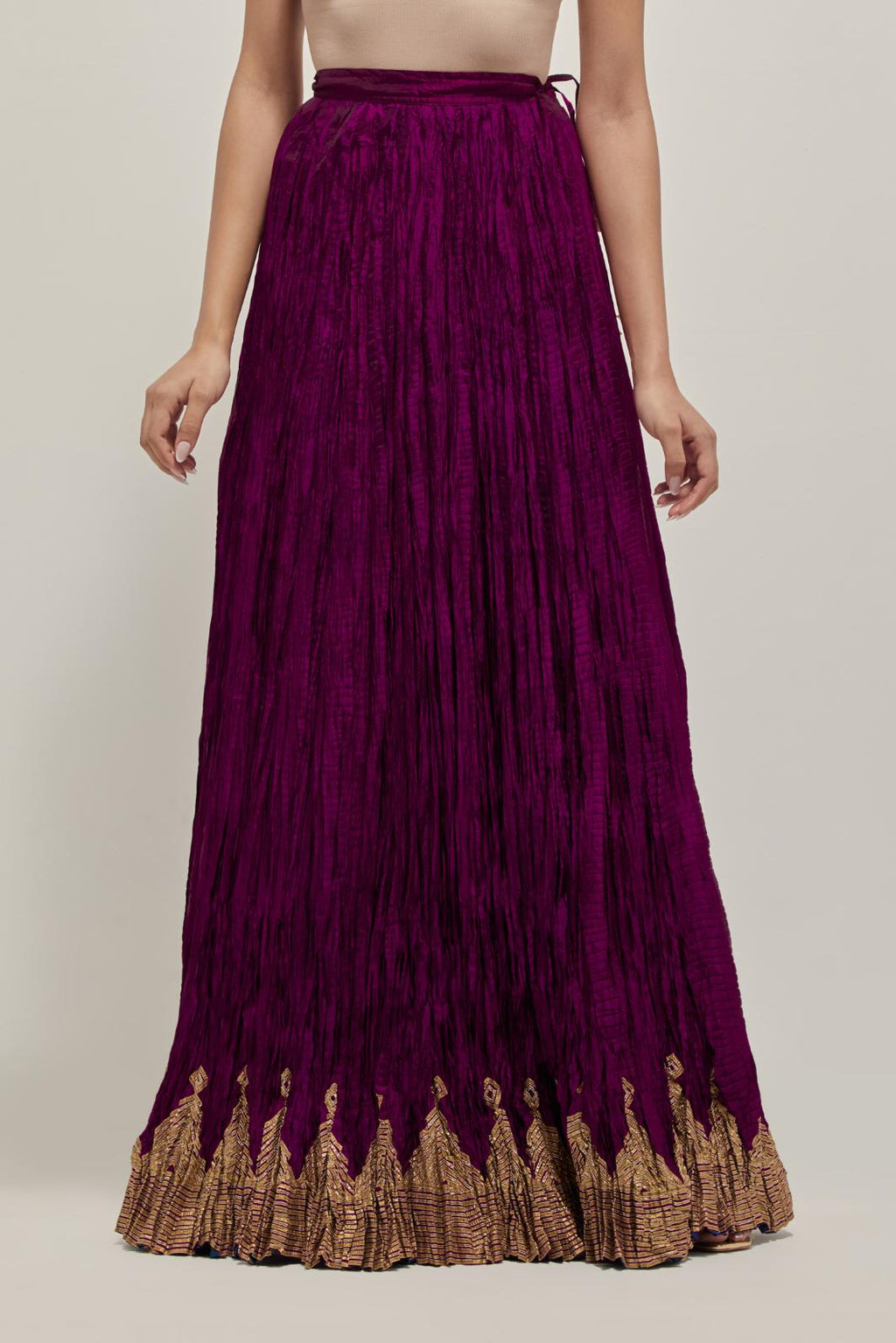 Wine Silk 40 kali lehenga edged with dull gold gota embroidery and contrast silk facings.