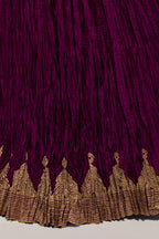 Wine Silk 40 kali lehenga edged with dull gold gota embroidery and contrast silk facings.
